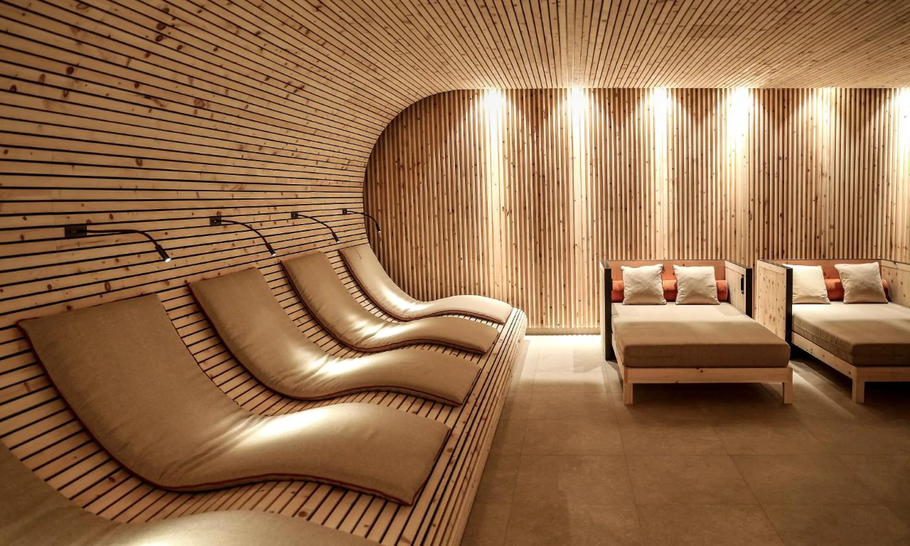 Wooden sauna with rounded enveloping walls.