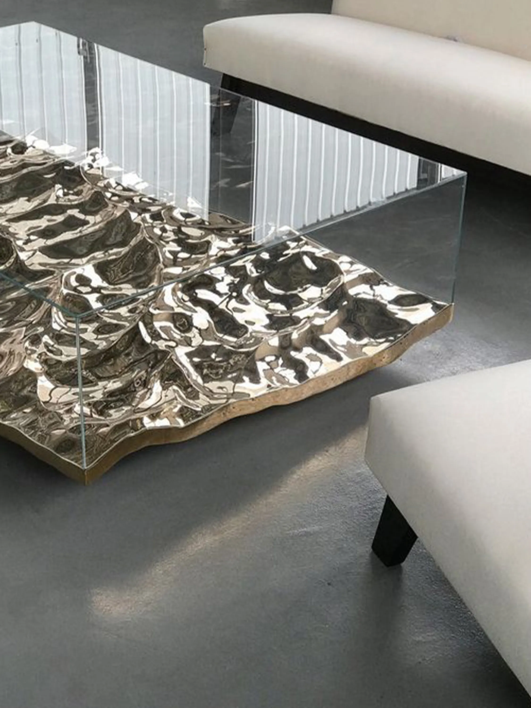 A cofee table with a bottom metal layer that feels like a wavy water.