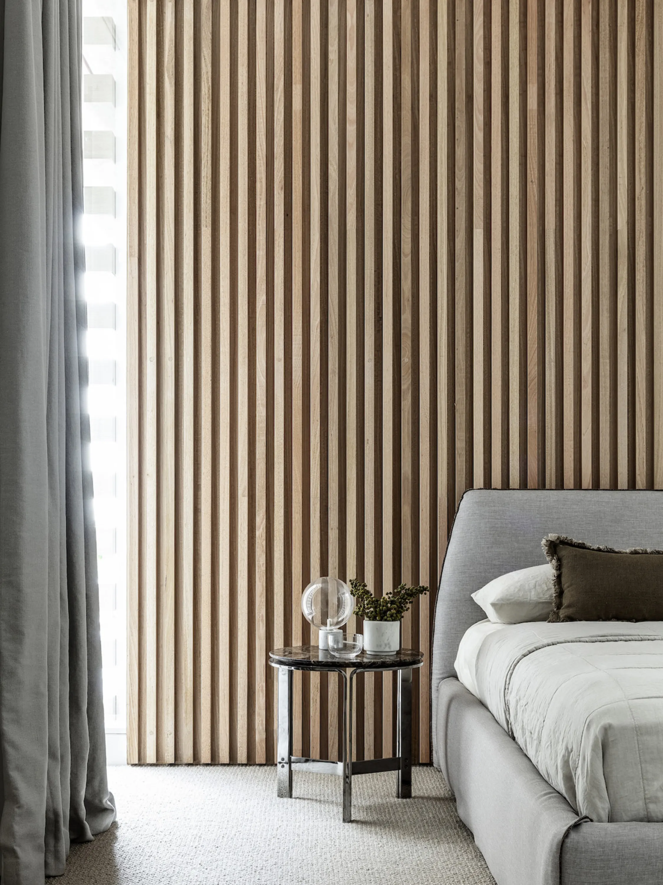 Bedroom with ribbed wood wall.