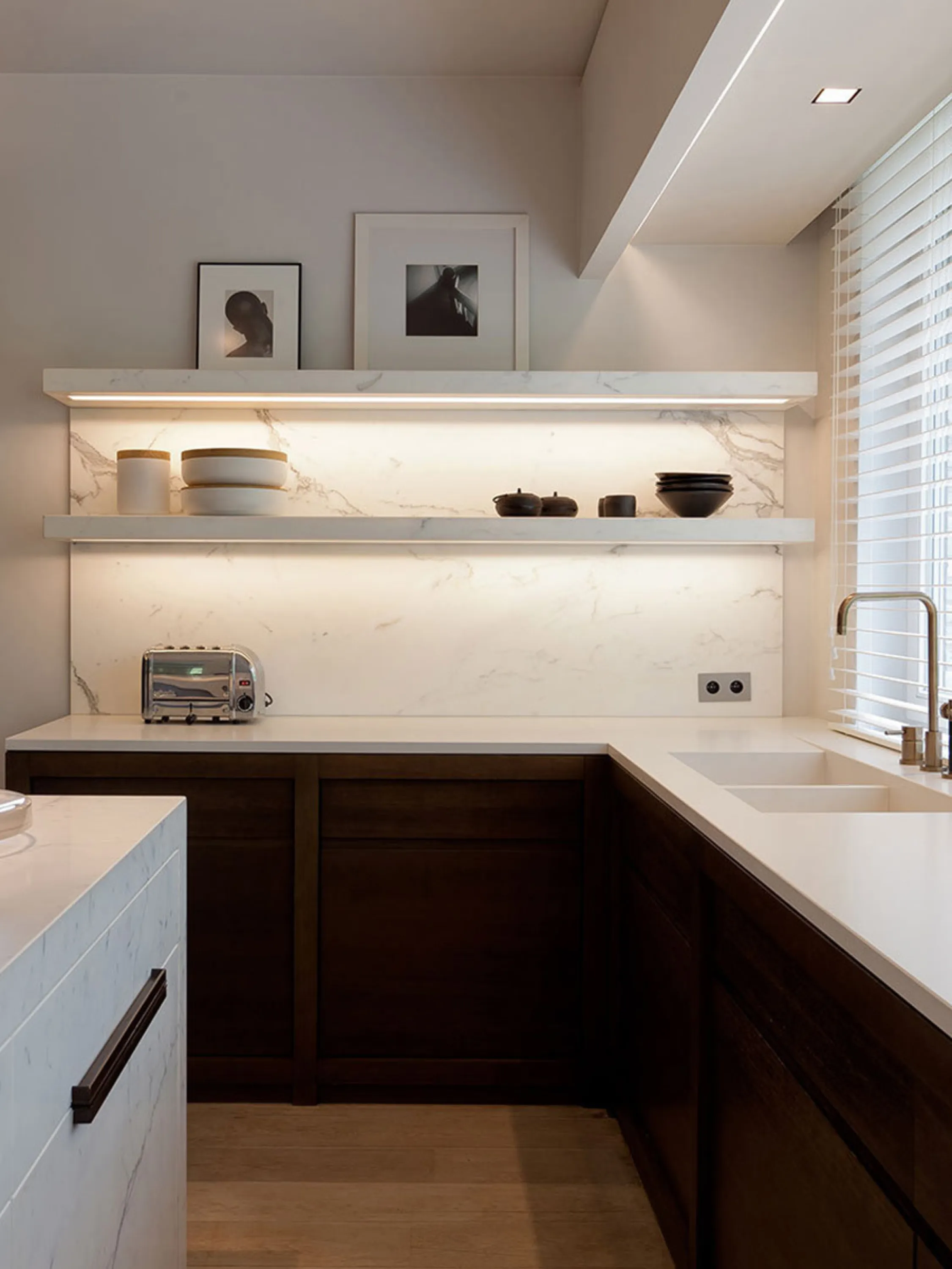 Minimalist kitchen design with lit shelves.