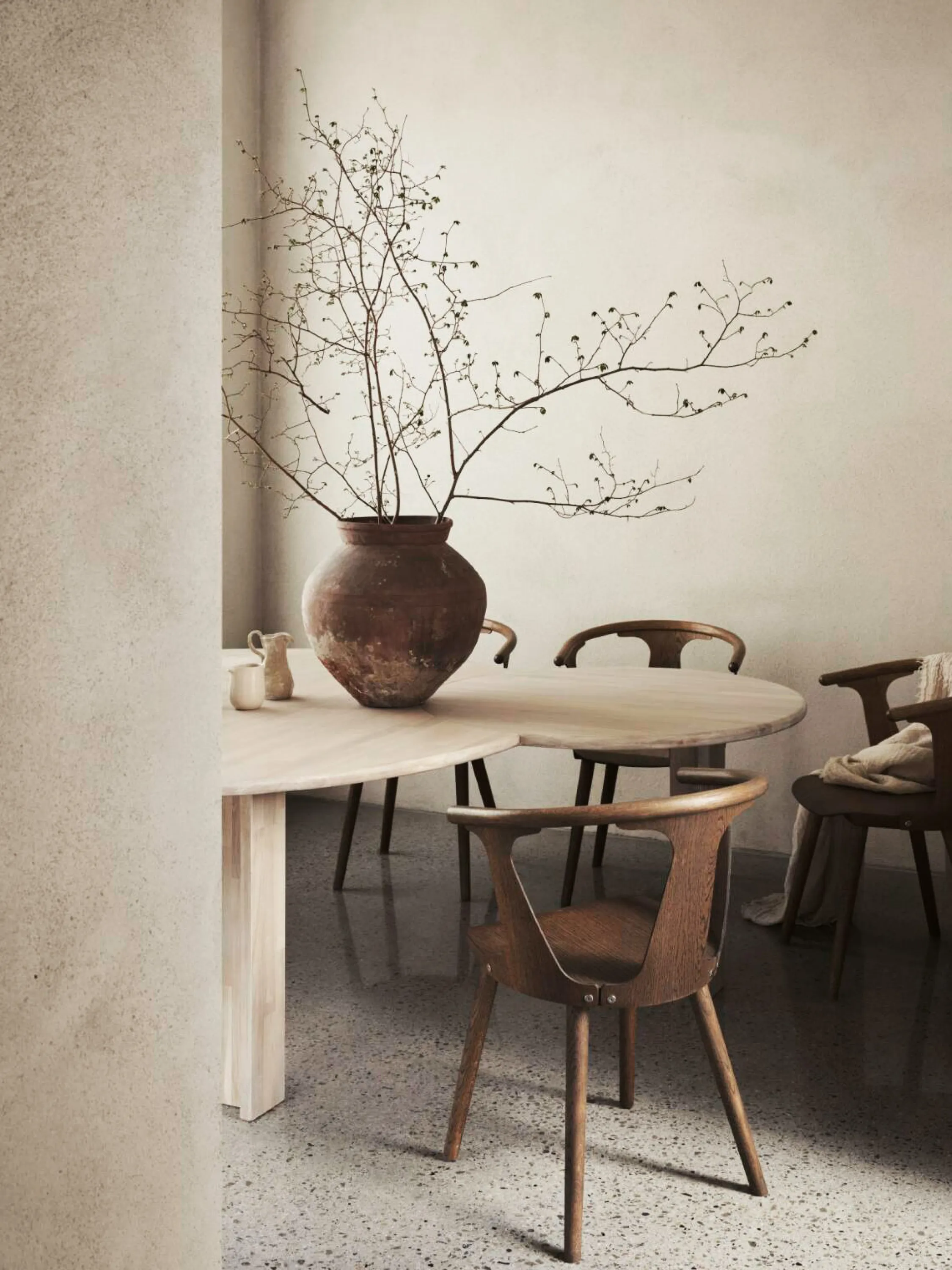 Inviting dining area with curved shapes and earthy textures.