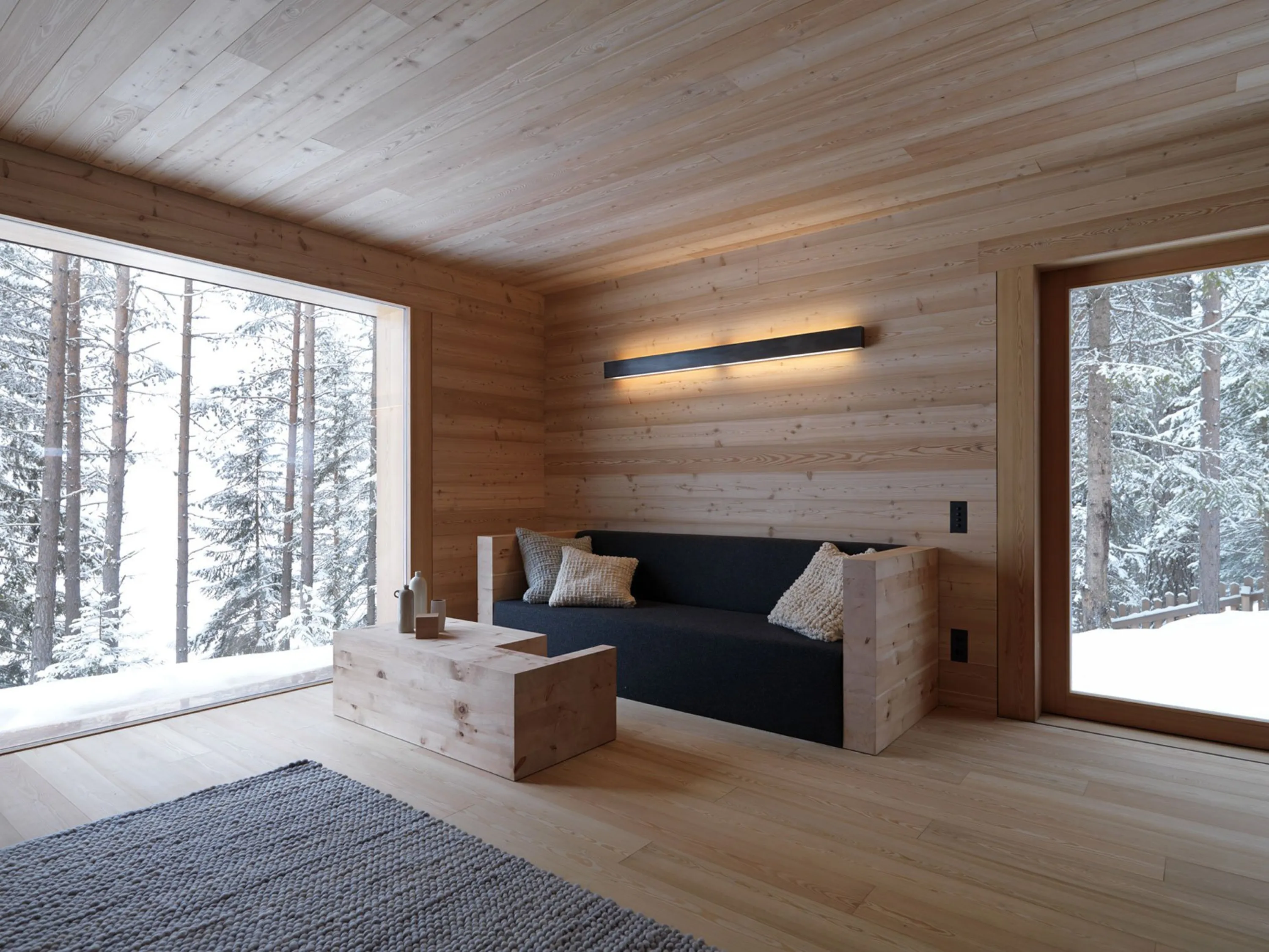 Living space with local wood panelling on floor and wall.