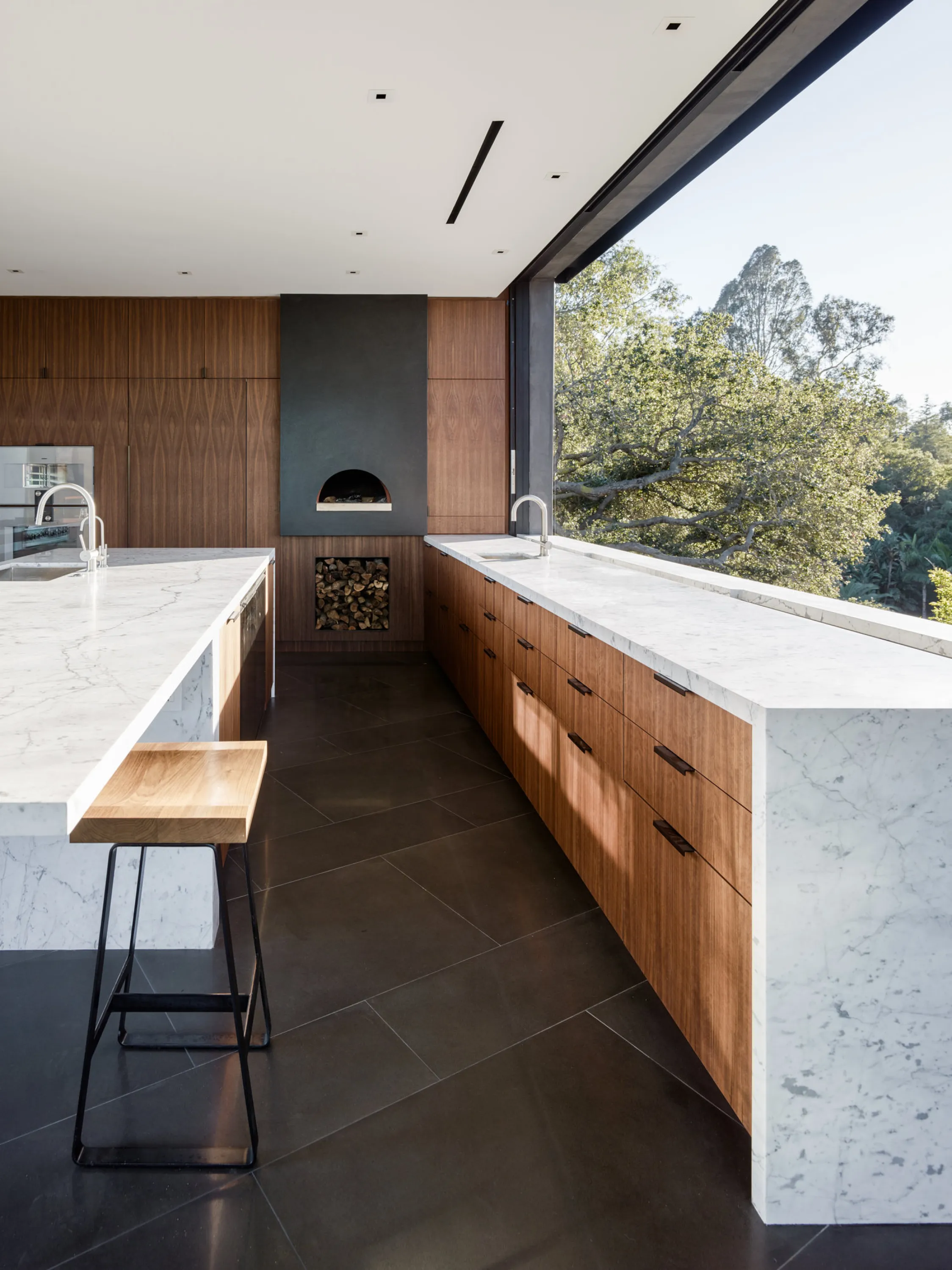 Kitchen with a huge window instead of a backsplash.