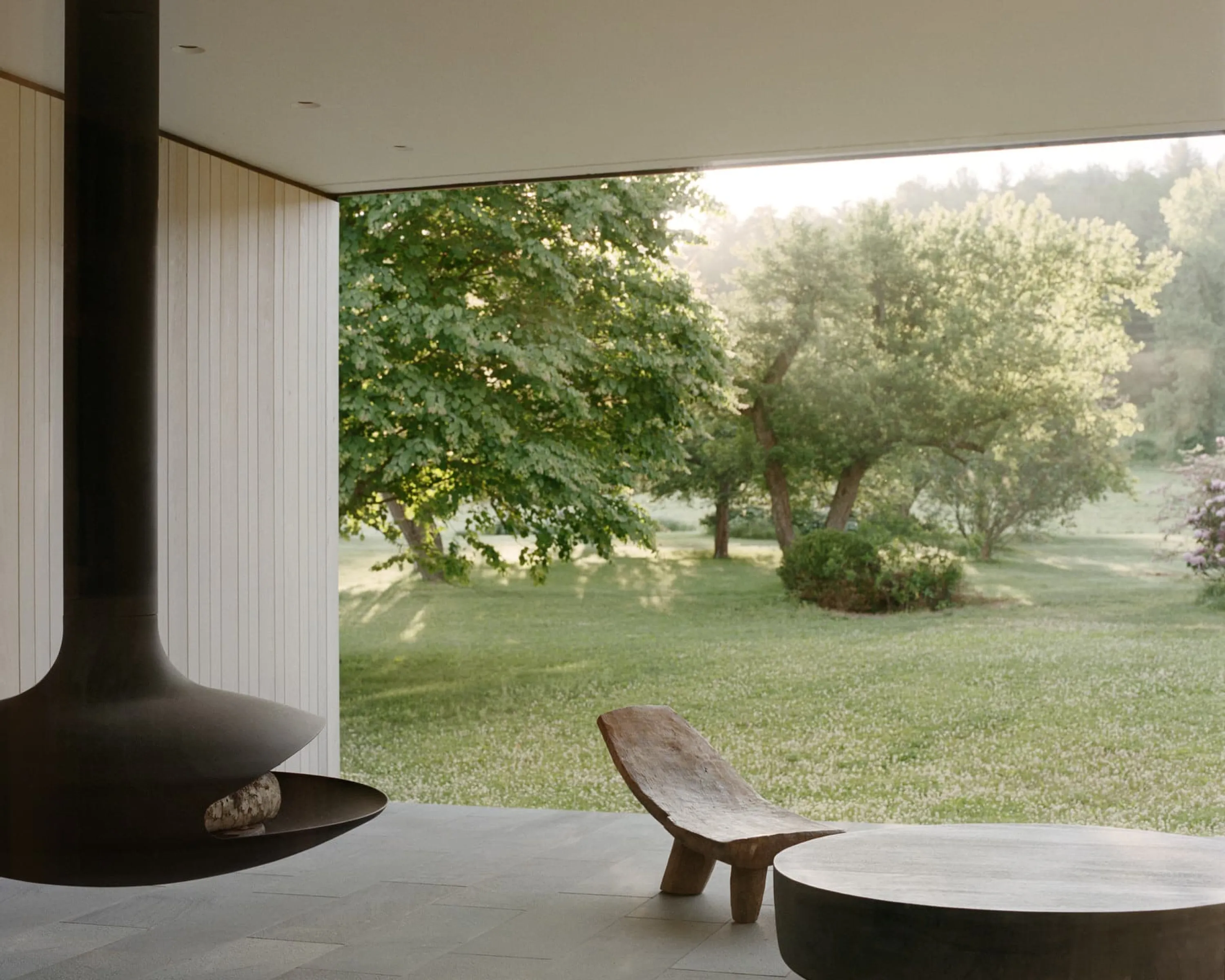 Outdoor seating area overlooking a lush garden.